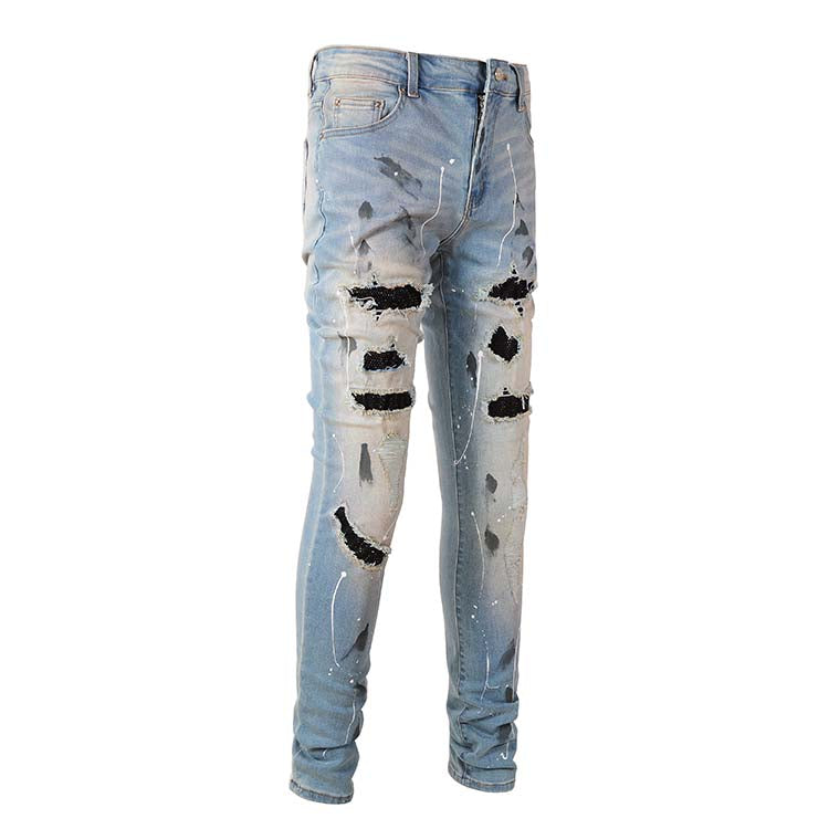 Jeans bleu déchire avec trace de peinture et surpiqûre noir