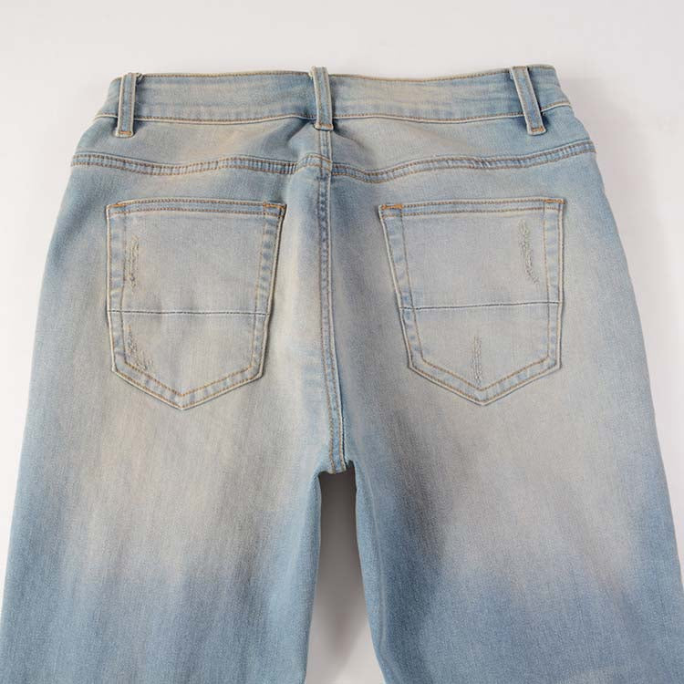 Jeans bleu déchire avec trace de peinture et surpiqûre noir